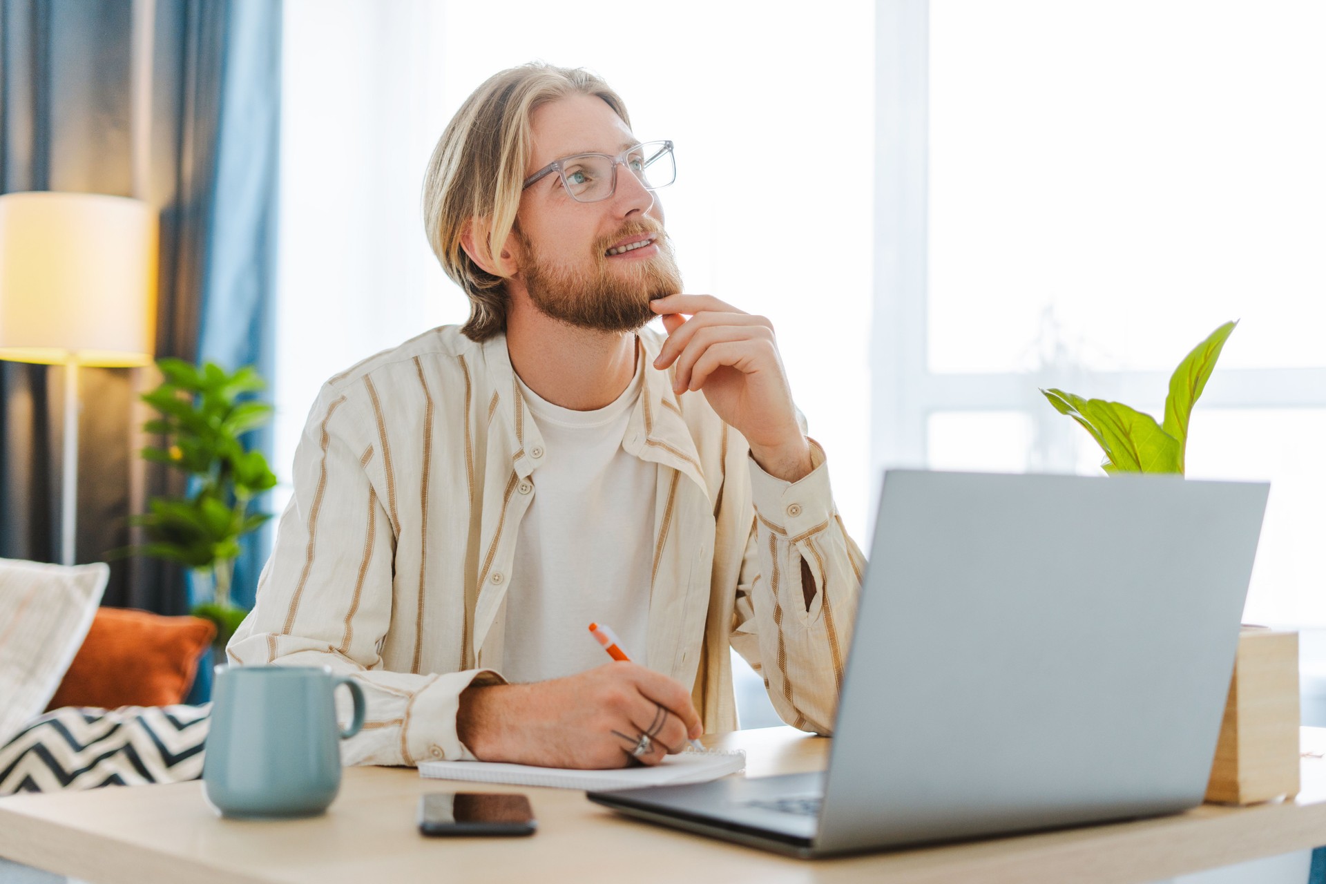 Young professional brainstorming new ideas while working remotely from home office